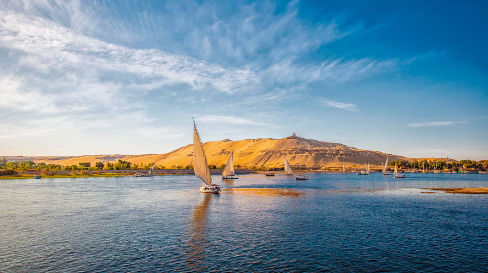 Traditional boats saile the Nile at sunset